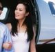 Happy business couple looking at each other together with airplane in the background at airfield Couple exiting private plane